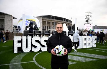 German former football player Philipp Lahm, also head of Germany's 2024 European Championship organizing committee, holds the official ball on November 15, 2023 at the Olympic Stadium in Berlin, Germany, during an event organised by sports equipment maker Adidas to present the official ball for the 2024 UEFA European Football Championship. (Photo by Tobias SCHWARZ / AFP)