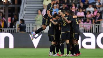 Apr 9, 2025; Ft. Lauderdale, Florida, USA; Los Angeles FC forward Denis Bouanga (99) jumps over his teammates as they celebrate a goal by defender Aaron Long (33) during the first half at Chase Stadium. Mandatory Credit: Sam Navarro-Imagn Images