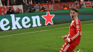 Bayern Munich's German midfielder #42 Lennart Karl celebrates scoring his team's second goal 2:1 during the UEFA Champions League, league phase - day 6 football match between Bayern Munich and Sporting CP in Munich, southern Germany, on December 9, 2025. (Photo by Alexandra BEIER / AFP)