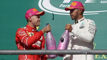 AUSTIN, TX - OCTOBER 22: Race winner Lewis Hamilton of Great Britain and Mercedes GP and second place finisher Sebastian Vettel of Germany and Ferrari on the podium during the United States Formula One Grand Prix at Circuit of The Americas on October 22, 2017 in Austin, Texas. Clive Mason/Getty Images/AFP
== FOR NEWSPAPERS, INTERNET, TELCOS & TELEVISION USE ONLY ==