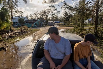 Nash Harris and his brother Waylon ride in the bed of their family's truck after Hurricane Helene tore through Steinhatchee, Florida.