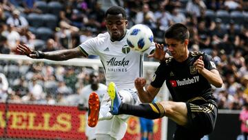 Portland Timbers defender Alvas Powell, left, of Jamaica, vies with Los Angeles FC defender Joao Moutinho, of Portugal, in the first half of an MLS soccer game in Los Angeles, Sunday, July 15, 2018. (AP Photo/Ringo H.W. Chiu)
