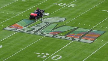 A worker prepares the field ahead of Super Bowl LVII between the Philadelphia Eagles and the Kansas City Chiefs at State Farm Stadium in Glendale, Arizona, on February 11, 2023. (Photo by ANGELA WEISS / AFP)