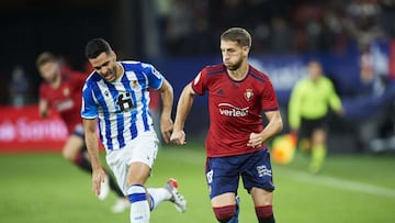 PAMPLONA, SPAIN - NOVEMBER 07: Darko Brasanac of CA Osasuna duels for the ball with Mikel Merino of Real Sociedad during the La Liga Santander match between CA Osasuna and Real Sociedad at Estadio El Sadar on November 07, 2021 in Pamplona, Spain. (Photo b