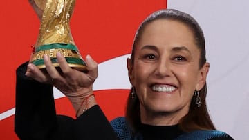 Mexico's President Claudia Sheinbaum lifts the FIFA World Cup trophy during her morning press conference at the National Palace, in Mexico City, Mexico, March 3, 2026. REUTERS/Stringer
