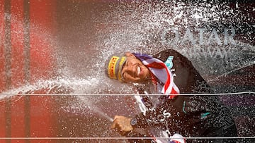 Mercedes' British driver Lewis Hamilton celebrates on the podium with champagne after winning the Formula One British Grand Prix at the Silverstone motor racing circuit in Silverstone, central England, on July 7, 2024. (Photo by BENJAMIN CREMEL / AFP)