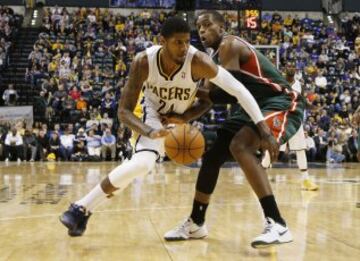 Paul George (24) dribbles the ball around  Milwaukee Bucks forward Khris Middleton (22) at Bankers Life Fieldhouse. The Pacers won 101-96. Mandatory  Credit: Brian Spurlock-USA TODAY Sports