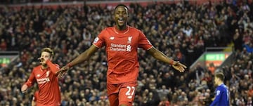 Origi (centre) celebrates scoring against Everton.