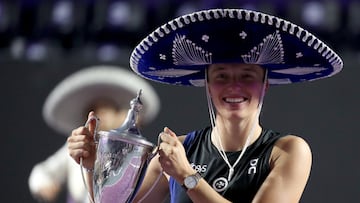 Poland's Iga Swiatek celebrates with the trophy after winning her final match against Jessica Pegula of the U.S.