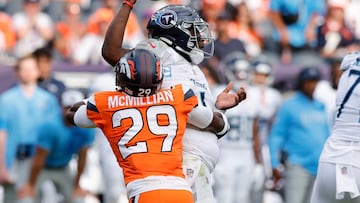 Sep 7, 2025; Denver, Colorado, USA; Denver Broncos cornerback Ja'Quan McMillian (29) hits Tennessee Titans quarterback Cam Ward (1) causing a fumble in the second half at Empower Field at Mile High. Mandatory Credit: Isaiah J. Downing-Imagn Images
