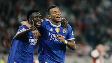 Real Madrid's Kylian Mbappe, right, celebrates with his teammate Vinicius Junior after scoring his side's fourth goal during the Champions League opening phase soccer match between Olympiacos and Real Madrid, in in Piraeus port, near Athens, Greece, Wednesday, Nov. 26, 2025. (AP Photo/Petros Giannakouris)