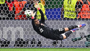 Portugal's goalkeeper #22 Diogo Costa saves a penalty shot by Slovenia's defender #03 Jure Balkovec (unseen) during a penalty shout-out during the UEFA Euro 2024 round of 16 football match between Portugal and Slovenia at the Frankfurt Arena in Frankfurt am Main on July 1, 2024. (Photo by Kirill KUDRYAVTSEV / AFP)