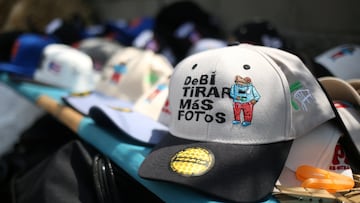 A vendor displays a cap with the slogan “Debi Tirar Mas Fotos” outside the Atanasio Girardot Stadium before Bad Bunny’s “DeBi TiRAR MaS FOToS” tour concert in Medellin, Colombia, January 23, 2026. REUTERS/Juan David Duque