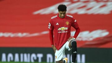 Manchester United's English striker Marcus Rashford 'takes a knee' in support of the No Room For Racism campaign ahead of the English Premier League football match between Manchester United and Leeds United at Old Trafford in Manchester, no
