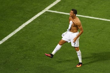 Cristiano Ronaldo of Real Madrid takes off his shirt in celebration after scoring the winning penalty in the penalty shoot out during the UEFA Champions League Final