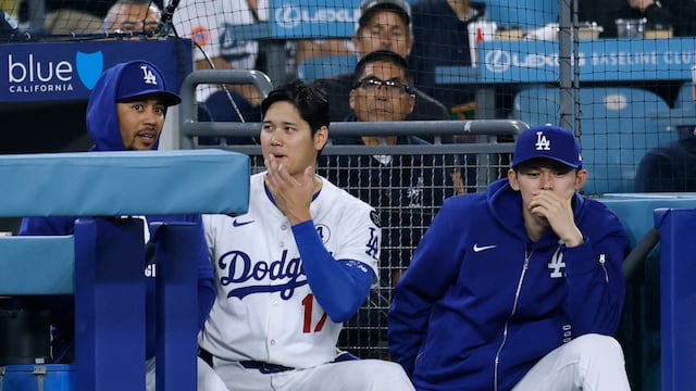 LOS ANGELES, CALIFORNIA - JUNE 02: Mookie Betts #50, Shohei Ohtani #17 and Roki Sasaki #11 of the Los Angeles Dodgers watch from the dugout during the 10th inning against the New York Mets at Dodger Stadium on June 02, 2025 in Los Angeles, California. Harry How/Getty Images/AFP (Photo by Harry How / GETTY IMAGES NORTH AMERICA / Getty Images via AFP)