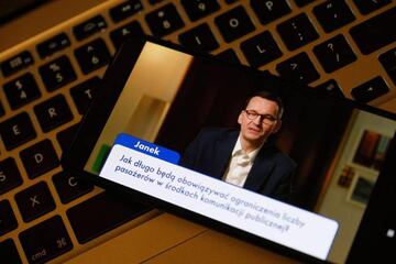 Warsaw (Poland), 21/04/2020.- A view of a screen showing Polish Prime Minister Mateusz Morawiecki answering questions on the coronavirus situation during a live web in Warsaw, Poland, 21 April 2020. Countries around the world are taking increased measures