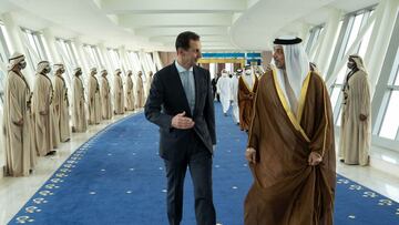 A handout picture released by the Syrian Presidency Facebook page on March 18, 2022, shows Syria&#039;s President Bashar al-Assad (L) is welcomed by the UAE&#039;s Deputy Prime Minister Sheikh Mansour bin Zayed Al-Nahyan, in the capital Abu Dhabi.. (Photo