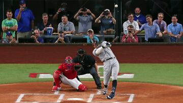 ARLINGTON, TX - OCTOBER 4: Aaron Judge #99 of the New York Yankees hits his 62nd home run of the season against the Texas Rangers during the first inning in game two of a double header at Globe Life Field on October 4, 2022 in Arlington, Texas. Judge has now set the American League record for home runs in a single season.   Ron Jenkins/Getty Images/AFP