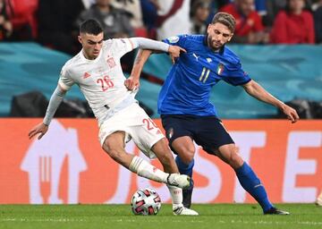 Spain's Pedri in action with Italy's Domenico Berardi