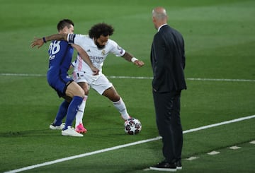 Marcelo pelea un balón ante la mirada de Zidane.
