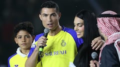 Portuguese forward Cristiano Ronaldo (C-L), accompanied by his partner Georgina Rodriguez (C-R) and his son Cristiano Ronaldo Jr, greets the crowd at the Mrsool Park Stadium in the Saudi capital Riyadh on January 3, 2023, upon his presentation as an Al-Nassr player. (Photo by FAYEZ NURELDINE / AFP)