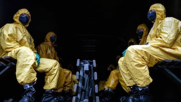 Brazil&#039;s military, firefighters and Civil Defense members sit on a military truck after disinfecting a bus station in Belo Horizonte, Brazil, on April 9, 2020, during the final stage of a course that prepared military personnel from all over the stat