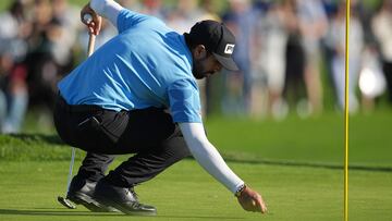 Matthieu Pavon tends the fifteenth green during the final round of the Farmers Insurance Open golf tournament at Torrey Pines Municipal Golf Course.