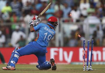 Afghanistan's Rashid Khan is bowled by South Africa's Chris Morris.