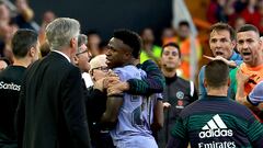 Real Madrid's Brazilian forward Vinicius Junior confronts Valencia's officials as he leaves after being sent off the pitch by the referee during the Spanish league football match between Valencia CF and Real Madrid CF at the Mestalla stadium in Valencia on May 21, 2023. (Photo by JOSE JORDAN / AFP)