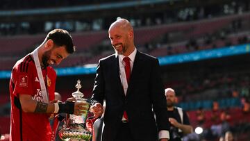 Manchester United's Dutch manager Erik ten Hag (R) and Manchester United's Portuguese midfielder #08 Bruno Fernandes hold the trophy as they celebrate their victory at the end of the English FA Cup final football match between Manchester City and Manchester United at Wembley stadium, in London, on May 25, 2024. Manchester United wins 2 - 1 against Manchester City. (Photo by Ben Stansall / AFP) / NOT FOR MARKETING OR ADVERTISING USE / RESTRICTED TO EDITORIAL USE
