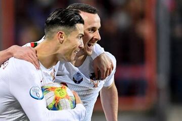 Portugal's forward Cristiano Ronaldo (L) celebrates after scoring a goal with Portugal's forward Diogo Jota during the UEFA Euro 2020 Group B qualification football match between Luxembourg and Portugal at the Josy Barthel Stadium in Luxembourg on November 17, 2019. (Photo by JOHN THYS / AFP)