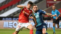 Sporting Braga&#039;s Portuguese forward Trincao (L) vies with FC Porto&#039;s Brazilian defender Alex Telles during the Portuguese League football match between Braga and Porto at the Braga Municipal Stadium in Braga on July 25, 2020. (Photo by MIGUEL RI