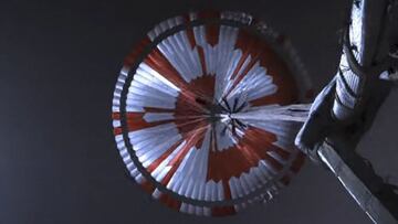 This NASA video frame grab photo released on February 22, 2021 shows what NASA's Mars 2020 Perseverance mission captured in footage of its rover landing in Mars' Jezero Crater on February 18, 2021, the real footage in this video was captured by several cameras that are part of the rover's entry, descent, and landing suite. The views include a camera looking down from the spacecraft's descent stage (a kind of rocket-powered jet pack that helps fly the rover to its landing site), a camera on the rover looking up at the descent stage, a camera on the top of the aeroshell (a capsule protecting the rover) looking up at that parachute, and a camera on the bottom of the rover looking down at the Martian surface. - The US space agency NASA on February 22, 2021 released the first video of the landing of the Perseverance rover on Mars. The video clip, lasting three minutes and 25 seconds, showed the deployment of the parachute and the rover's touchdown on the surface of the Red Planet. "These are really amazing videos," said Michael Watkins, director of NASA's Jet Propulsion Laboratory. "This is the first time we've ever been able to capture an event like the landing on Mars." (Photo by Lizabeth MENZIES / NASA / AFP) / RESTRICTED TO EDITORIAL USE - MANDATORY CREDIT "AFP PHOTO /NASA/JPL-Caltech/HANDOUT " - NO MARKETING - NO ADVERTISING CAMPAIGNS - DISTRIBUTED AS A SERVICE TO CLIENTS