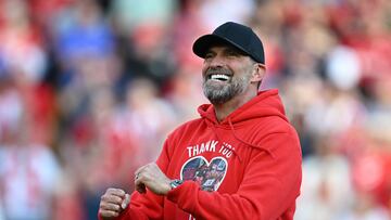 Liverpool's German manager Jurgen Klopp smiles as he makes his final farewell to fans after the English Premier League football match between Liverpool and Wolverhampton Wanderers at Anfield in Liverpool, north west England on May 19, 2024. Jurgen Klopp was given a heartfelt reception by home fans at Anfield as he walked out for his final match as Liverpool manager on Sunday. Klopp, who arrived at the club in October 2015, won seven major trophies at Liverpool, including the club's first league title for 30 years and the 2019 Champions League. (Photo by Paul ELLIS / AFP) / RESTRICTED TO EDITORIAL USE. No use with unauthorized audio, video, data, fixture lists, club/league logos or 'live' services. Online in-match use limited to 120 images. An additional 40 images may be used in extra time. No video emulation. Social media in-match use limited to 120 images. An additional 40 images may be used in extra time. No use in betting publications, games or single club/league/player publications. / 