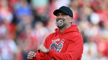 Liverpool's German manager Jurgen Klopp smiles as he makes his final farewell to fans after the English Premier League football match between Liverpool and Wolverhampton Wanderers at Anfield in Liverpool, north west England on May 19, 2024. Jurgen Klopp was given a heartfelt reception by home fans at Anfield as he walked out for his final match as Liverpool manager on Sunday. Klopp, who arrived at the club in October 2015, won seven major trophies at Liverpool, including the club's first league title for 30 years and the 2019 Champions League. (Photo by Paul ELLIS / AFP) / RESTRICTED TO EDITORIAL USE. No use with unauthorized audio, video, data, fixture lists, club/league logos or 'live' services. Online in-match use limited to 120 images. An additional 40 images may be used in extra time. No video emulation. Social media in-match use limited to 120 images. An additional 40 images may be used in extra time. No use in betting publications, games or single club/league/player publications. /