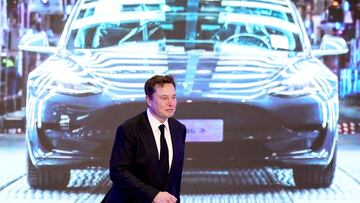 FILE PHOTO: Tesla Inc CEO Elon Musk walks next to a screen showing an image of Tesla Model 3 car during an opening ceremony for Tesla China-made Model Y program in Shanghai, China January 7, 2020. REUTERS/Aly Song/File Photo