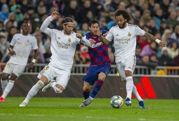 Lionel Messi tussles for the ball with Sergio Ramos and Marcelo during El Clásico on Sunday.