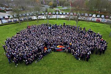 El piloto neerlandés Max Verstappen posa sentado en el neumático delantero de su coche, con todos los miembros del equipo Red Bull, como flamante campeón del mundo 2021 de Fórmula 1 en la sede del equipo austriaco situada en Milton Keynes. En la rueda trasera, el jefe del equipo, Christian Horner.