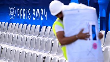 A man works at the opening ceremony tribune on the embankment of river Seine ahead of the Paris 2024 Olympic and Paralympic Games, in Paris on July 20, 2024. (Photo by Kirill KUDRYAVTSEV / AFP)