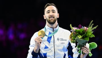 Winner Israel's Artem Dolgopyat celebrates on the podium after the Men's Floor Final during the 52nd FIG Artistic Gymnastics World Championships, in Antwerp, northern Belgium, on October 7, 2023. (Photo by Lionel BONAVENTURE / AFP)