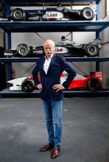 El jefe de Daimler AG, Dieter Zetsche posa delante de varios coches de Fórmula 1 clásicos de Mercedes.