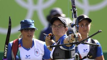 Italy's Lucilla Boari, releases her arrow as Claudia Mandia, right, and Guendalina Sartori look at her during the women's team archery competition at the Sambadrome venue during the 2016 Summer Olympics in Rio de Janeiro, Brazil, Sunday, Aug. 7, 2016. (AP Photo/Alessandra Tarantino)
