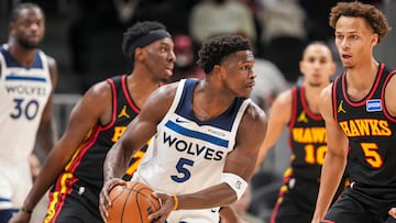 Minnesota Timberwolves guard Anthony Edwards (5) looks to pass in front of Atlanta Hawks guard Dyson Daniels (5) during the first half at State Farm Arena.