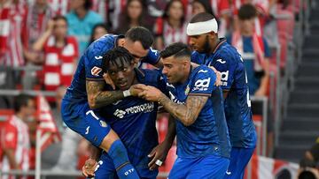 Getafe's Nigerian forward #06 Christantus Uche (2L) celebrates with teammates scoring his team's first goal during the Spanish league football match between Athletic Club Bilbao and Getafe CF at the San Mames stadium in Bilbao on August 15, 2024. (Photo by ANDER GILLENEA / AFP)