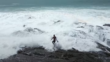 Surfistas entrando al agua en Snapper Rocks, entre potentes olas y rocas.