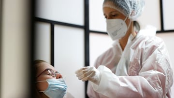 A medical worker administers a nasal swab to a patient at a coronavirus disease (COVID-19) testing centre in Les Sorinieres near Nantes, as PCR and antigenic tests, necessary for unvaccinated to get a valid health pass, become charged, excluding medical prescriptions, in France, October 15, 2021. REUTERS/Stephane Mahe