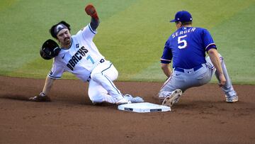 PHOENIX, ARIZONA - NOVEMBER 01: Corbin Carroll #7 of the Arizona Diamondbacks steals second base past Corey Seager #5 of the Texas Rangers in the first inning during Game Five of the World Series at Chase Field on November 01, 2023 in Phoenix, Arizona.   Sean M. Haffey/Getty Images/AFP (Photo by Sean M. Haffey / GETTY IMAGES NORTH AMERICA / Getty Images via AFP)