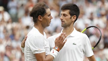 (FILES) In this file photo taken on July 14, 2018 Serbia's Novak Djokovic (R) shakes hands after beating Spain's Rafael Nadal during the continuation of their men's singles semi-final match on the twelfth day of the 2018 Wimbledon Championships at The All England Lawn Tennis Club in Wimbledon, southwest London. - Novak Djokovic and Rafael Nadal headline the title chase at Wimbledon where eight-time champion Roger Federer, the world's top two players and cherished ranking points will all be missing. Djokovic is bidding for a seventh title at the All England Club to move level with US great Pete Sampras. Nadal, fresh from a 14th French Open victory and a record-extending 22nd major, is halfway to the first men's calendar Grand Slam in more than half a century. (Photo by NIC BOTHMA / POOL / AFP) / RESTRICTED TO EDITORIAL USE