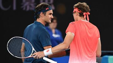 Switzerland's Roger Federer (L) shakes hands with Uzbekistan's Denis Istomin after winning their men's singles match on day one of the Australian Open tennis tournament in Melbourne on January 14, 2019. (Photo by WILLIAM WEST / AFP) / -- IMAGE RESTRICTED TO EDITORIAL USE - STRICTLY NO COMMERCIAL USE --